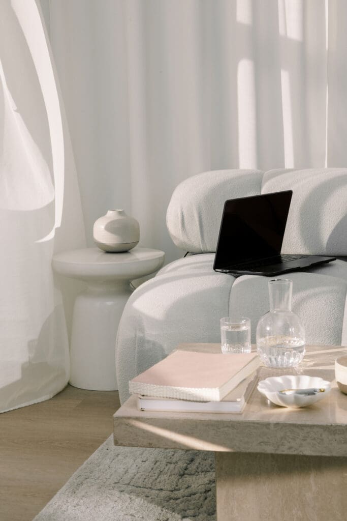 Minimal neutral workspace with laptop and decor, Showit vs Squarespace blog visual, calm creative office setting
