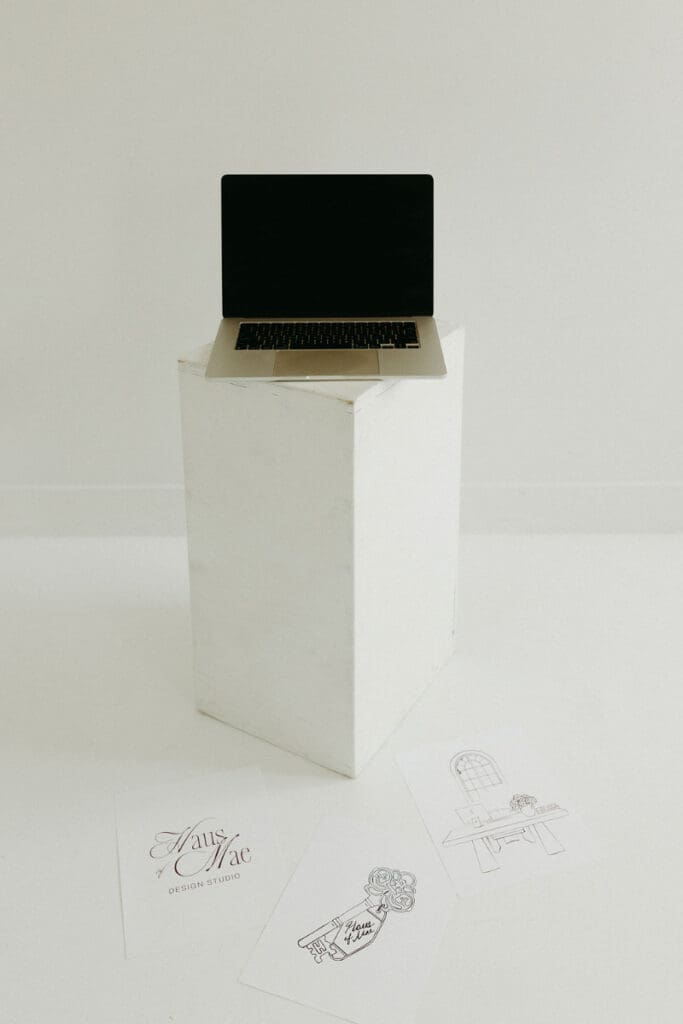 Minimal workspace with laptop on pedestal, symbolizing an outdated website ready for a refined, elevated redesign