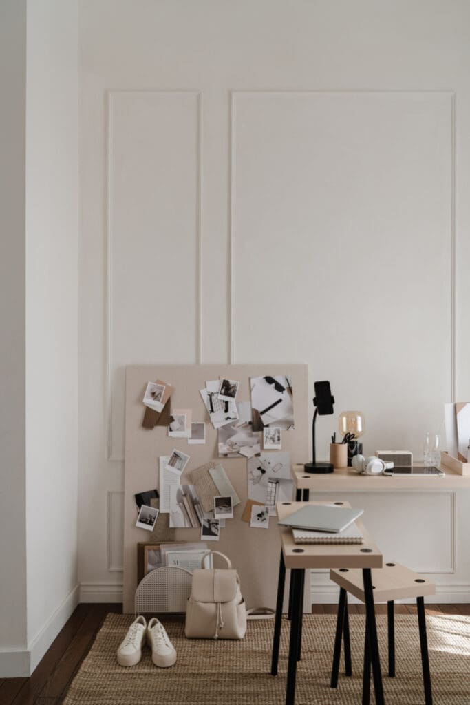Neutral workspace with mood board, desk setup, and minimal tools arranged for creative planning and design