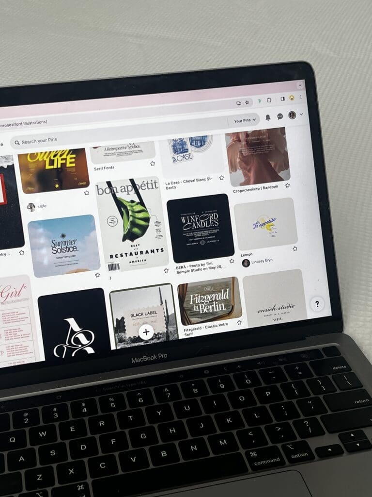 MacBook displaying Pinterest typography inspiration and font design examples while researching custom fonts for a Showit website.