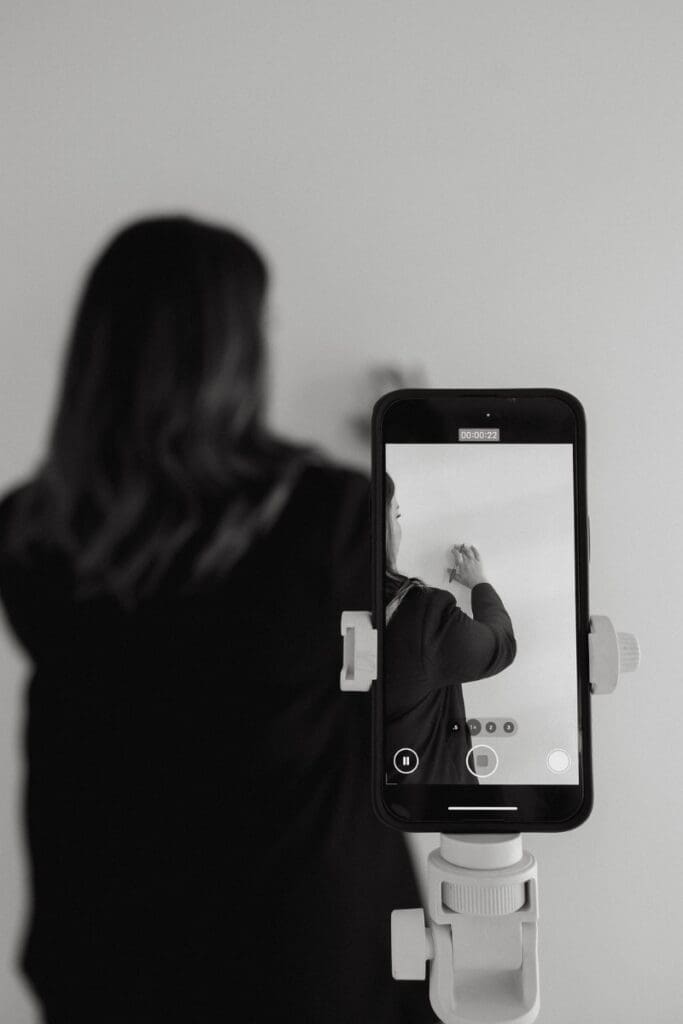 Designer recording behind-the-scenes content while working on a client branding project.